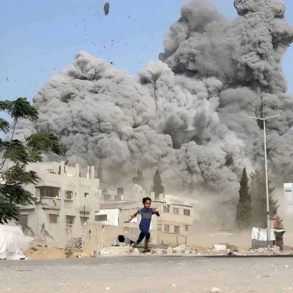 A child runs in terror as a massive explosion engulfs a residential street in Gaza — concrete buildings collapsing into dust, smoke rising hundreds of feet, debris in the air. 2025.