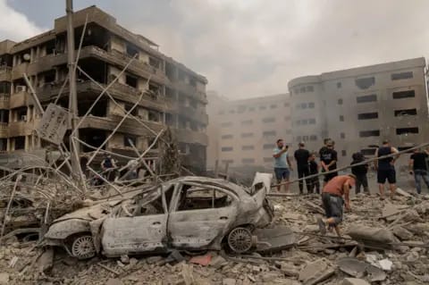 Beirut Lebanon airstrike aftermath - collapsed residential building, rubble in street, survivors picking through debris, 2024